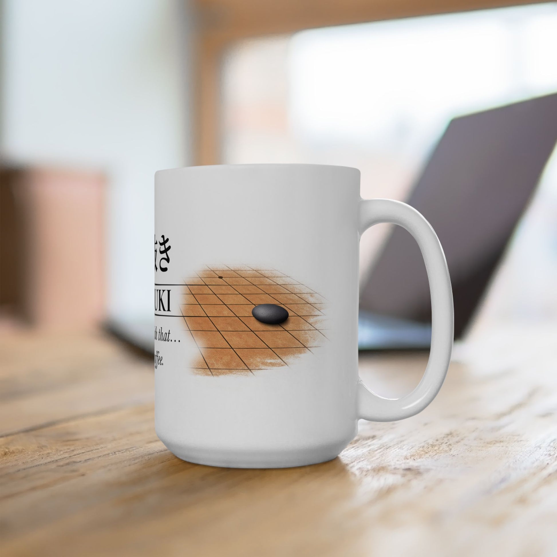 White mug with a design of a go board and stone on a wooden surface.